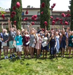 OHS Middle School students throwing hats into air